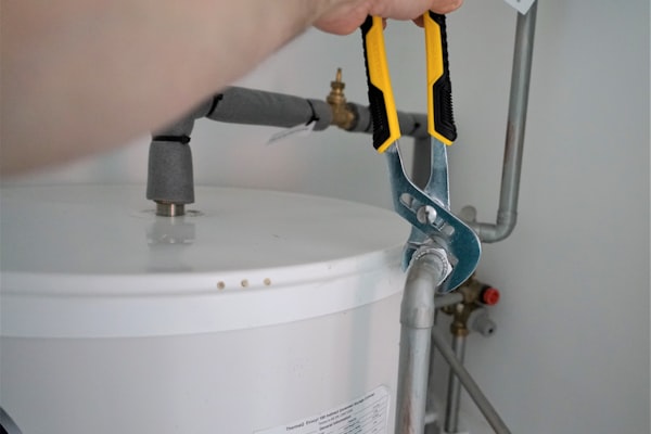 Professional plumber holding tools ready for service